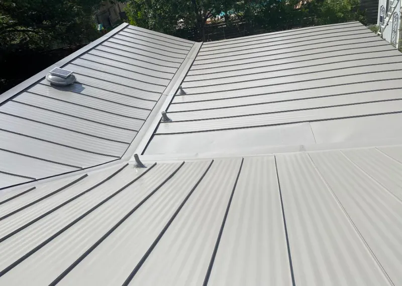 Solar attic fan installed on a metal roof for Roof Ventilation in Wall